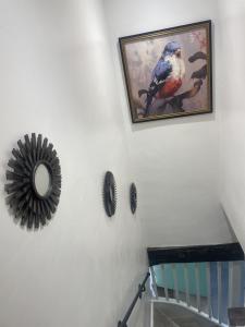 a painting of a bird on a wall with feathers at Grade 2 Cottage 1 bedroom, Ludlow centre in Ludlow