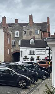 a bunch of cars parked in front of a building at Grade 2 Cottage 1 bedroom, Ludlow centre in Ludlow
