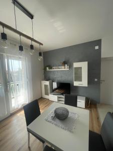 a living room with a table and a dining room at app Leka in Umag