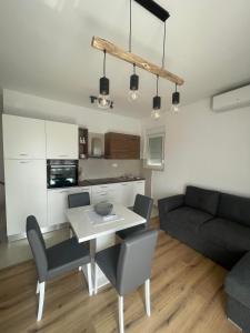a kitchen and living room with a table and chairs at app Leka in Umag