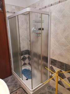a shower with a glass door in a bathroom at Ampia camera con balcone privato in Pordenone +57 photos