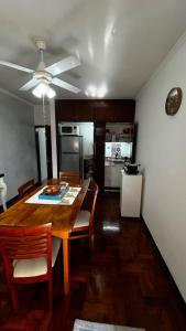 a kitchen with a wooden table and a dining room at Temporarios en Avellaneda Centro in Avellaneda