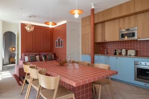 a kitchen with a table and chairs in a room at New Flat Terracotta Style - Greater Paris district in Malakoff