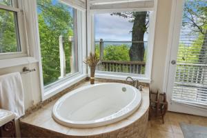 a large bath tub in a bathroom with windows at Ridgeline Views in Boone