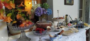a table topped with bowls of fruit and other food at Casale del Cantico in Brenta