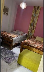 une chambre avec deux lits et deux tapis dans l'établissement شاليه للإيجار في راس سدر جولدن بيتش2, à Raʼs Matarma 7 autres photos