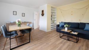 a living room with a blue couch and a table at Captains Quarters 5 in Dahme in Dahme