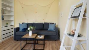 a living room with a couch and a table at Captains Quarters 5 in Dahme in Dahme