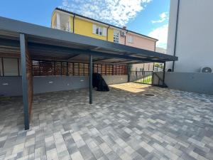 an empty garage with a building in the background at Apartmen ARMINAN 52 TERRACE, POOL FREE PARKING -NOVIGRAD in Novigrad Istria