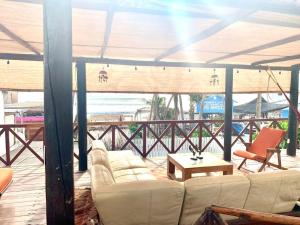 a living room with white couches and a table at Casa de las Olas Surf & Beach Club in Acapulco