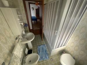 a bathroom with a shower and two toilets and a sink at VistaMare in San Foca +16 photos