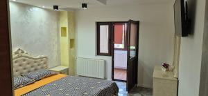 a bedroom with a bed and a door to a hallway at Apartament Roman in Roman