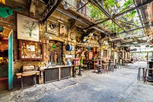 an old building with tables and chairs in it at Wellness Wonderland Garden, Sauna, Jacuzzi in CBD in Budapest
