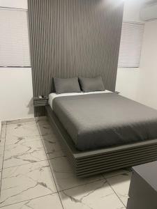 a bed sitting in a room with at LEVEL suites premium in Sosúa