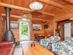 a living room with a stove and a table at 6 person holiday home in Roslev-By Traum in Roslev