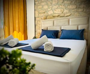 a bedroom with a bed with towels on it at Apartment Stone Mostar in Mostar