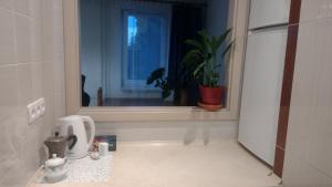 a kitchen with a window and a coffee maker on a counter at Apartament Pułaskiego in Rzeszów +5 photos