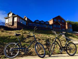 two bikes parked in front of a house at Weskar Lodge Hotel in Puerto Natales