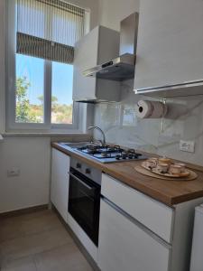 a kitchen with a stove and a plate of food at Casa Bice in Forio d'Ischia