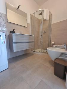 a bathroom with a shower and a tub and a sink at Casa Bice in Forio d'Ischia