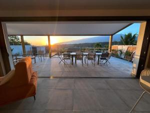 a view of a patio with a table and chairs at Villa Eclats Panoramiques in Saint-Pierre