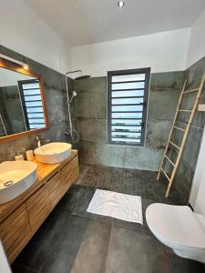 a bathroom with two sinks and a mirror at Villa Eclats Panoramiques in Saint-Pierre +28 photos
