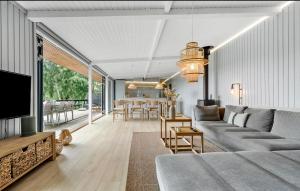 a living room with a couch and a dining room at 3 Bedroom Nice Home In Ebeltoft in Ebeltoft