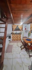 a kitchen with a table and a table and chairs at Pouso da Cajaíba - Chalé Pedaço de Céu in Paraty +66 photos