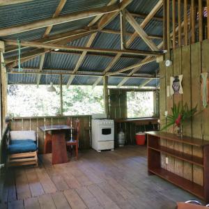 a large room with a table and a stove at Pavones Rustic Jungle Cabin in Pavones