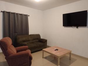 a living room with a couch and a coffee table at Departamento Rubi in Puerto Peñasco