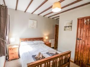 a bedroom with a bed with two towels on it at Carters in Staintondale
