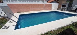 a swimming pool in the backyard of a house at Sierras in La Falda