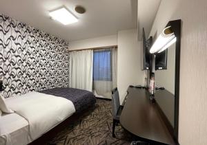 Giường trong phòng chung tại APA Hotel Kitakami Ekinishi