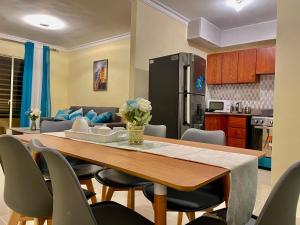 a kitchen and dining room with a table and chairs at Posada del caribe in La Cana