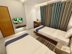 Postel nebo postele na pokoji v ubytování Hotel Nandini