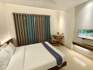 Postel nebo postele na pokoji v ubytování Hotel Nandini