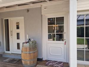 a door to a house with a barrel next to it at Boardinghouse Forst in Forst