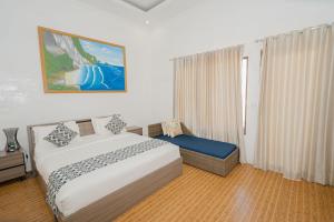 a hotel room with a bed and a window at Pandawa Resort & Spa Seaview in Nusa Penida