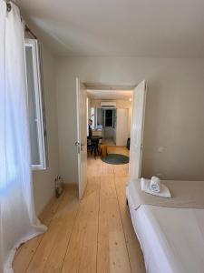 a bedroom with a bed and a room with a table at THE CENTRIC Apt by LOC HOSPITALITY in Corfu Town +12 photos