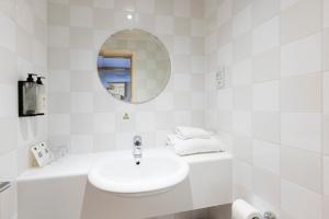 a white bathroom with a sink and a mirror at Holiday Inn - Glasgow Airport by IHG in Paisley