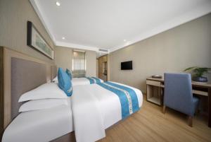 Postel nebo postele na pokoji v ubytování 义乌商洲宾馆国际商贸城店Yiwu Shangzhou Hotel - International Trade City