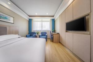 TV a/nebo společenská místnost v ubytování 义乌商洲宾馆国际商贸城店Yiwu Shangzhou Hotel - International Trade City