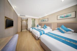 Postel nebo postele na pokoji v ubytování 义乌商洲宾馆国际商贸城店Yiwu Shangzhou Hotel - International Trade City