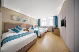 Postel nebo postele na pokoji v ubytování 义乌商洲宾馆国际商贸城店Yiwu Shangzhou Hotel - International Trade City