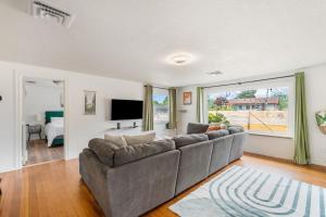 a living room with a couch and a tv at Charming Family-Friendly 2 Bedroom 1 Bathroom Retreat Near Astoria & Beach in Warrenton