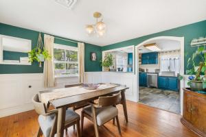 a dining room with blue walls and a table and chairs at Charming Family-Friendly 2 Bedroom 1 Bathroom Retreat Near Astoria & Beach in Warrenton