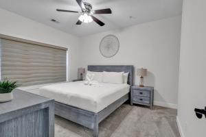 a bedroom with a bed and a ceiling fan at Elegant 3BR Condo - Magnolia North 101 in Myrtle Beach +28 photos