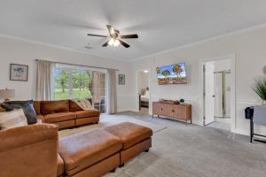 a living room with a couch and a ceiling fan at Elegant 3BR Condo - Magnolia North 101 in Myrtle Beach