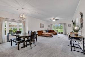 a living room with a table and chairs and a couch at Elegant 3BR Condo - Magnolia North 101 in Myrtle Beach
