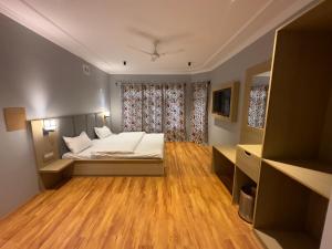 a small bedroom with a bed and a window at Silk Route in Srinagar +28 photos